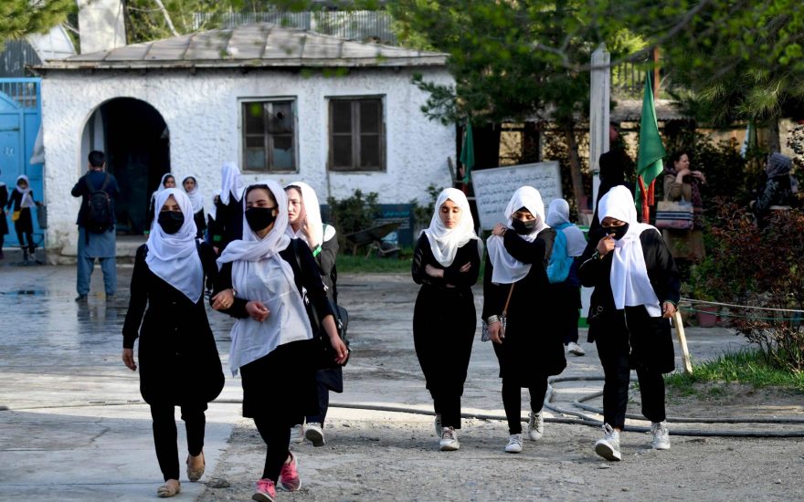 Girls arrive at their school in Kabul on March 23, 2022. - The reopening of secondary schools for girls across Afghanistan on March 23 prompted joy and apprehension among the tens of thousands of students deprived of an education since the Taliban's return to power. (Photo by Ahmad SAHEL ARMAN / AFP)
